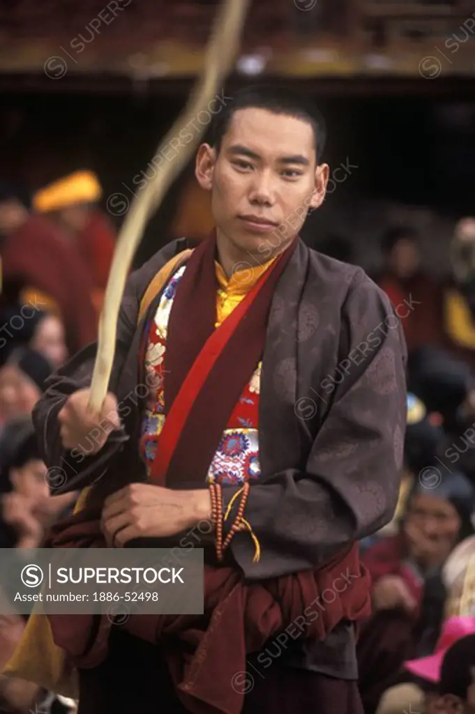 A monk disciplinarian at the Cham Dances, a form of Buddhist opera, Katok Monastery - Kham, (Tibet), Sichuan, China