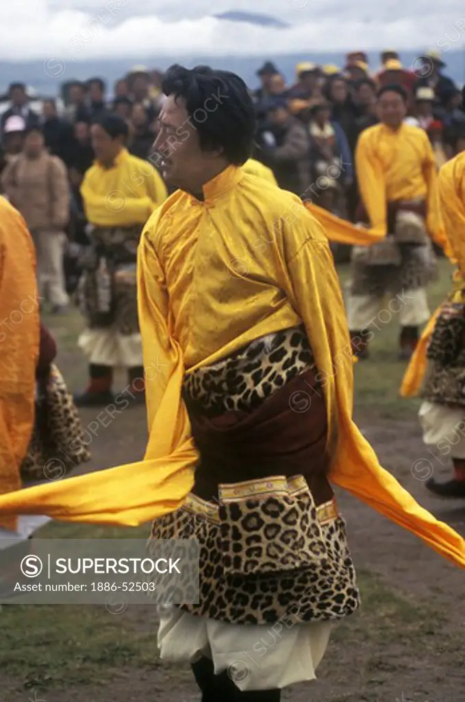Male dancer with leopard skin costume representing a region of Kham - Litang Horse Festival, Sichuan Province, China
