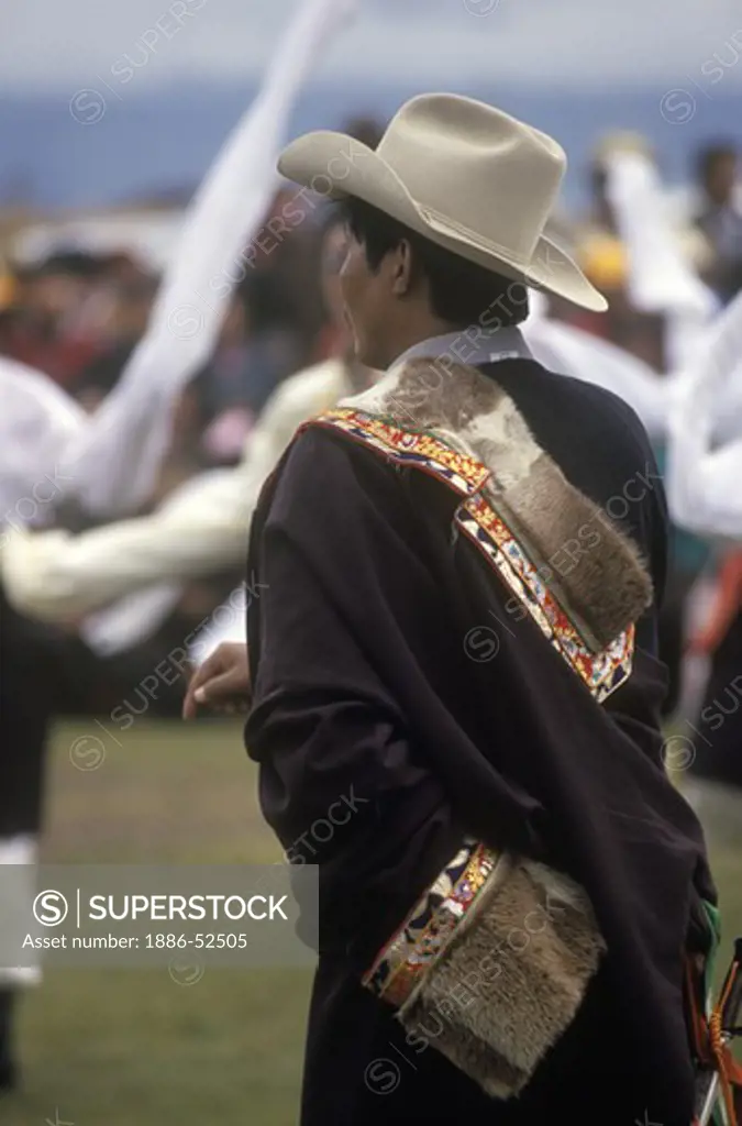 Male dancer with otter skin costume representing a region of Kham - Litang Horse Festival, Sichuan Province, China