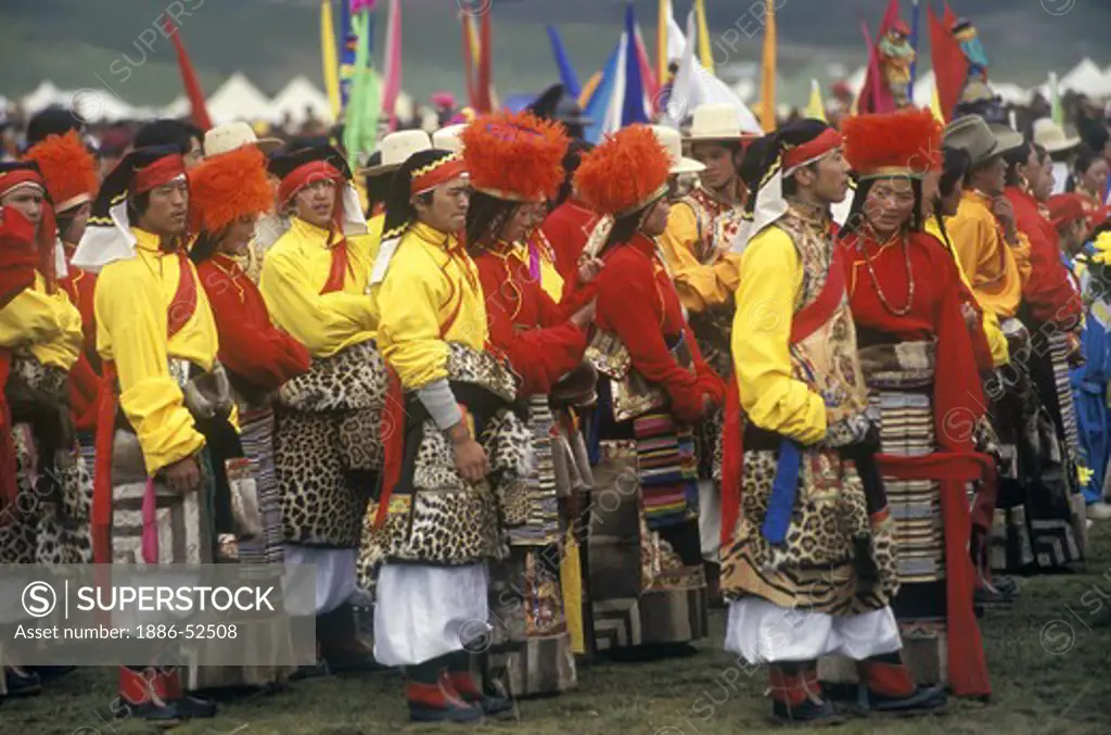 Dance troop with leopard skin costumes represent a region of Kham - Litang Horse Festival, Sichuan Province, China