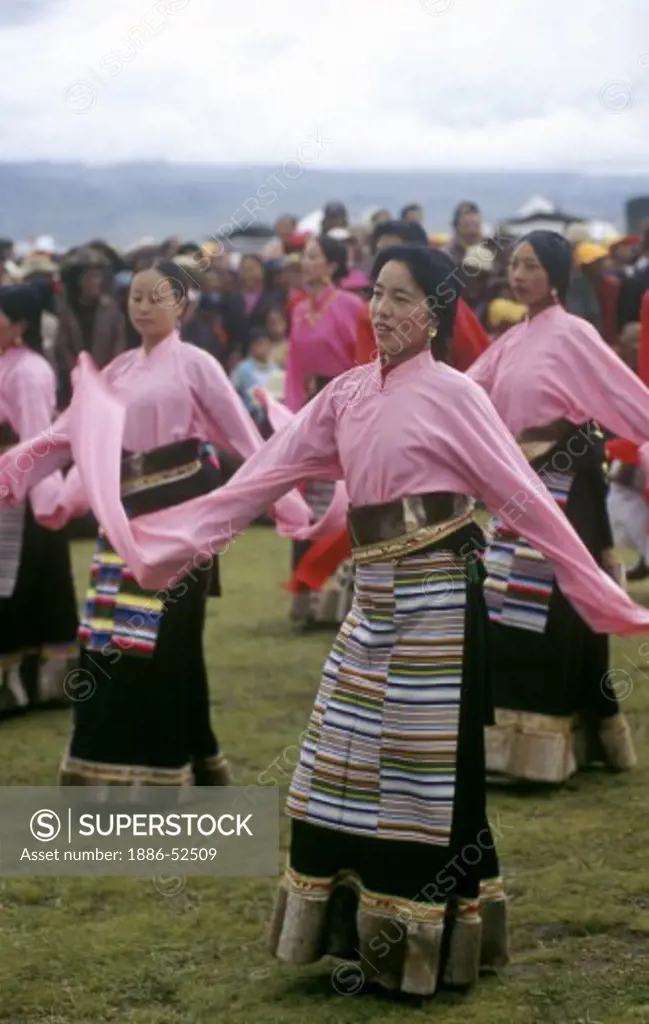 Female Dance troop with otter fur lined chubas preform at the Litang Horse Festival - Kham (Tibet) Sichuan Province, China
