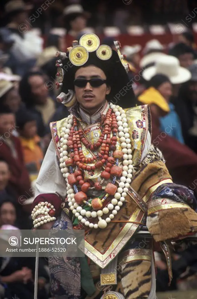 Male Khampa wears tiger skin, coral, zee stones & gold gau boxes at the Litang Horse Festival - Sichuan Province, China, (Tibet)