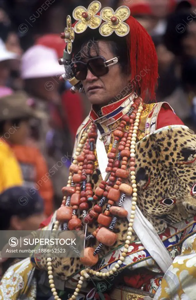 Male Khampa wears leopard skin, coral, zee stones & gold gau boxes at the Litang Horse Festival - Sichuan Province, China, (Tibet)