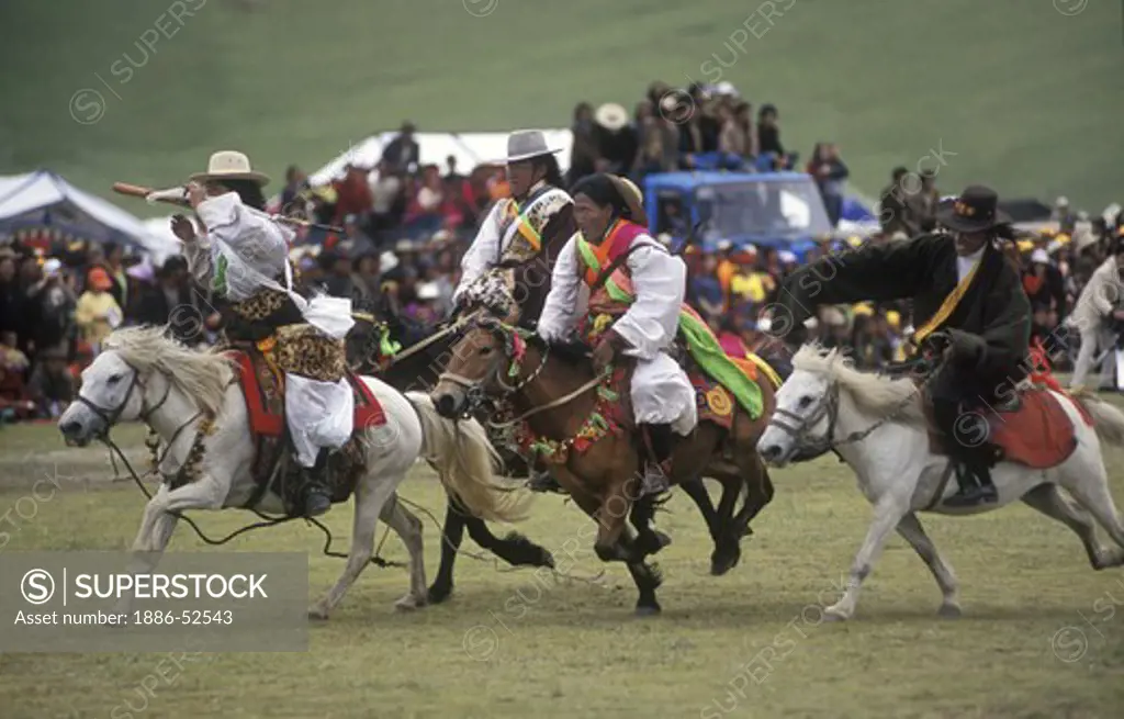Khampas entertain the crowd by racing at the Litang Horse Festival starting August 1st - Sichuan Province, China, (Tibet)