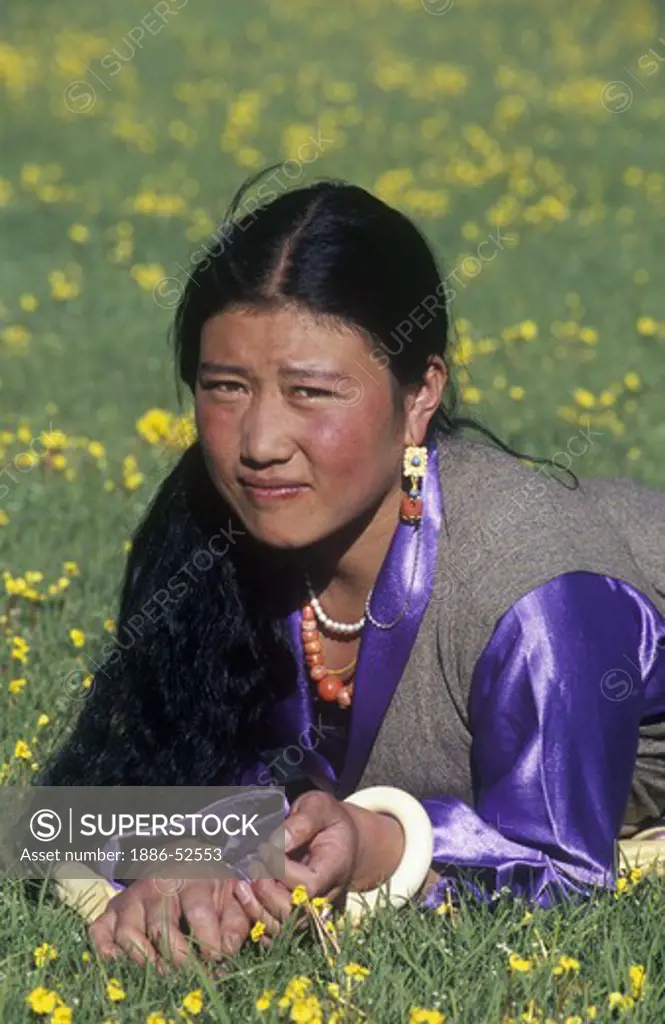 Pretty Khampa girl poses in the grasslands of Litang County, Kham - Sichuan Province, China, (Tibet)