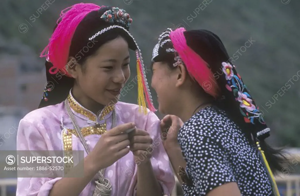 Girls of the Qiang tribe in traditional dress in town of Danba - Sichuan Province, China, (Tibet)