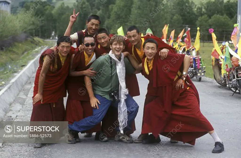 Tibetan Buddhist monks with American man in the Zi-chu Valley - Kham, (Eastern Tibet), Sichuan Province, China