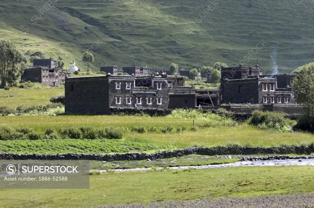 Traditional Tibetan style stone houses & river in the highlands of Kham - Sichuan Province, China, (Tibet)