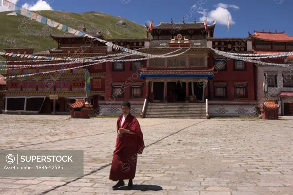 Buddhist monk in courtyard  of Tagong  Monastery (Lhagang Gompa) - Kham (E. Tibet), Sichuan Province, China