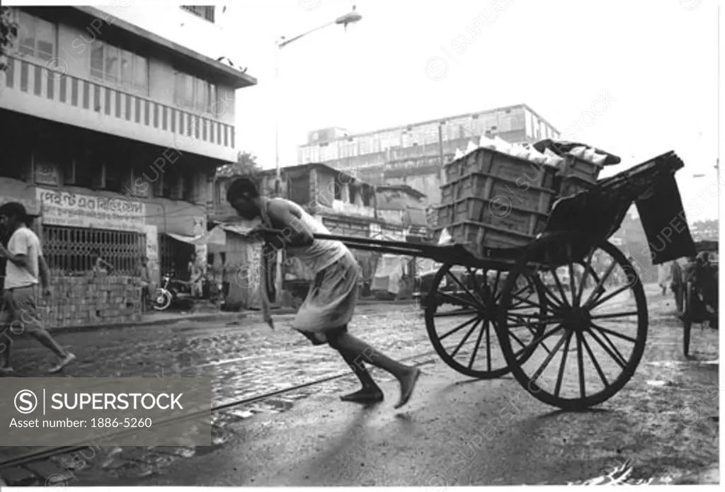 Hand-drawn rickshaw man struggling on the brick-lined bad roads, of Calcutta city, India.