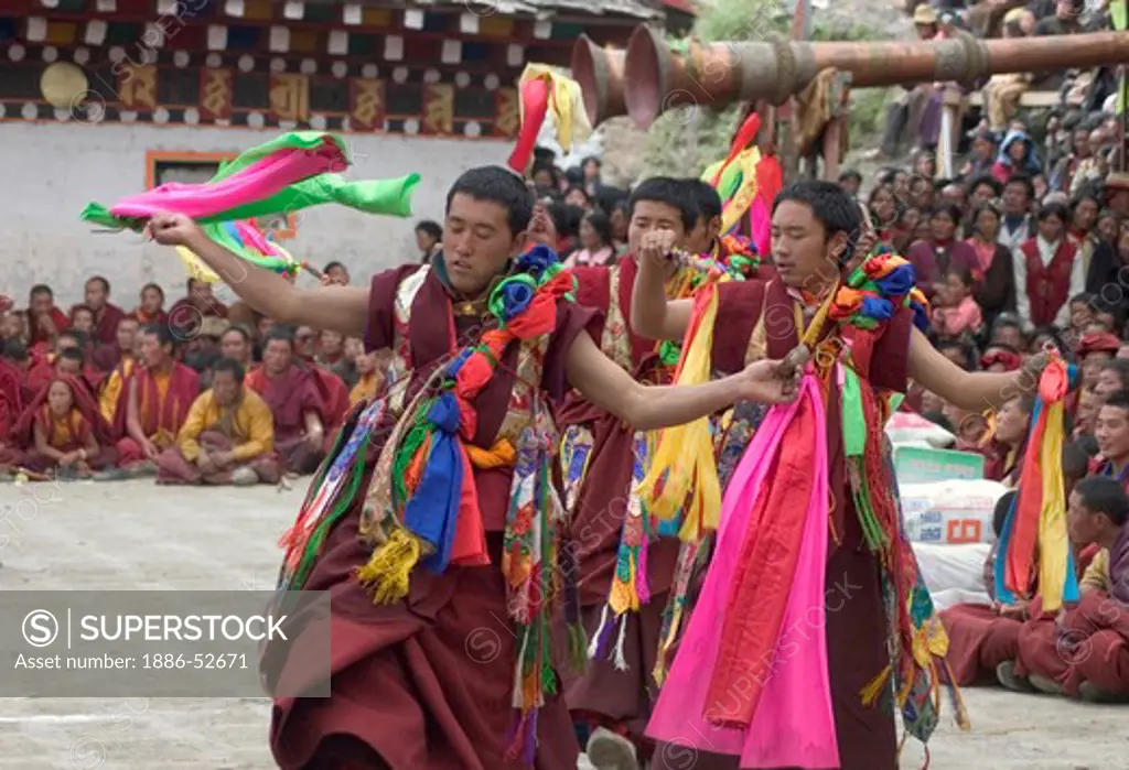 Monks dance with ribbons representing deity powers at the Monlam Chenmo, Katok Monastery - Kham, (Tibet), Sichuan, China