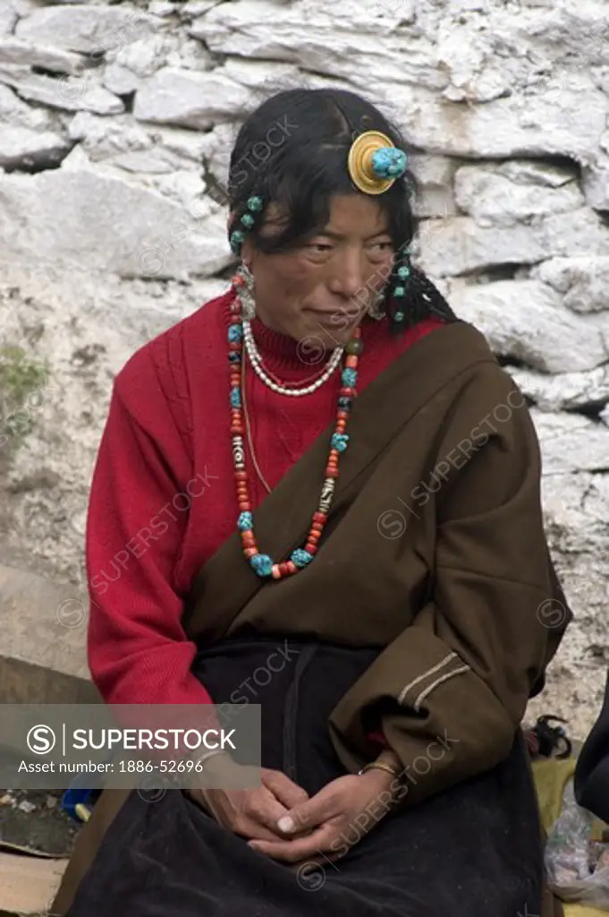 Khampa woman traditionally dressed at the Monlam Chenmo, Katok Dorjeden Monastery - Kham, (Tibet), Sichuan Province, China
