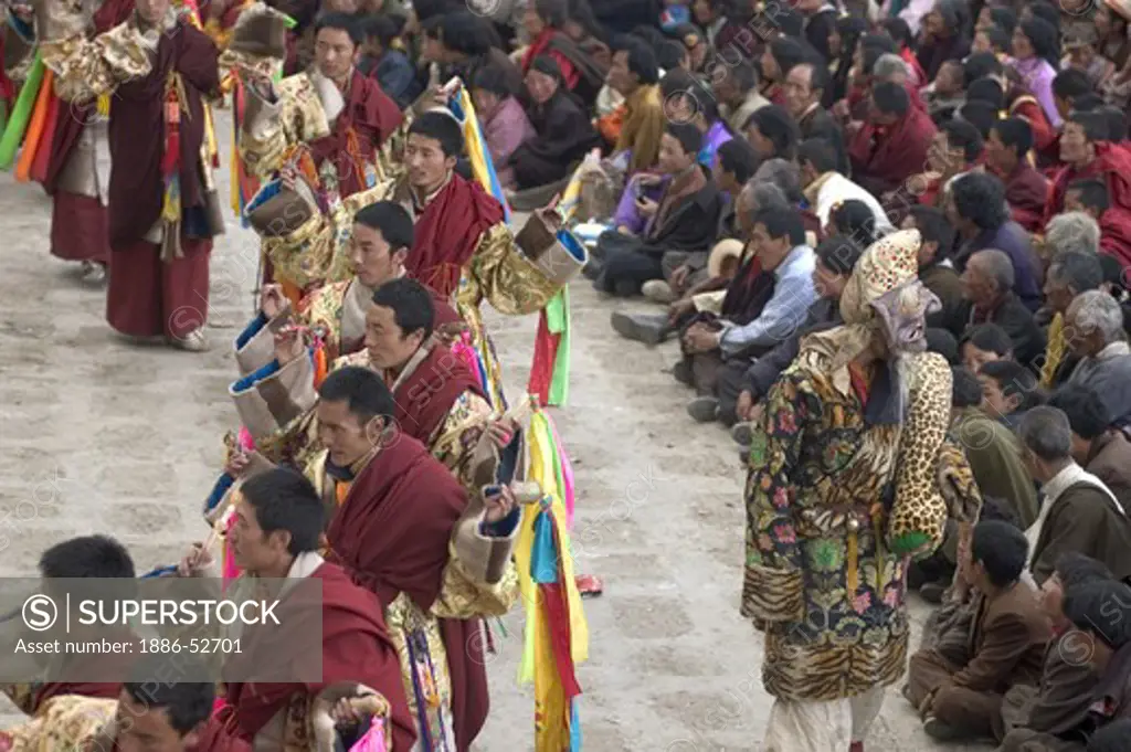 Monks dance with ribbons representing deity powers at the Monlam Chenmo, Katok Monastery - Kham, (Tibet), Sichuan, China