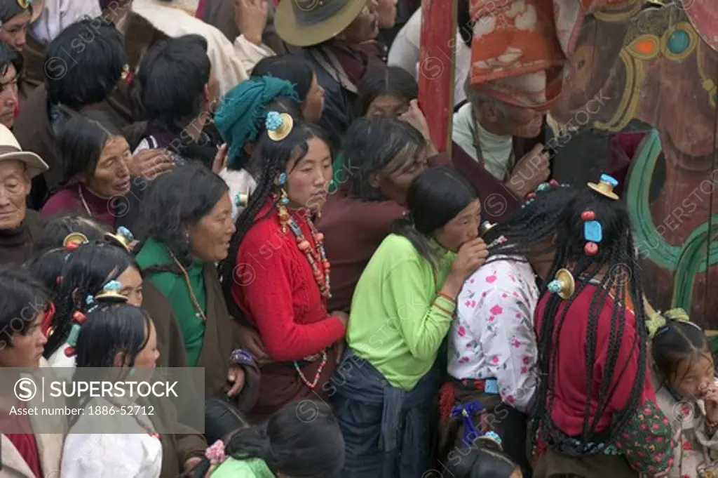 A crowd watches the Monlam Chenmo dances below a Tongchen (Tibetan Horn),  Katok Monastery - Kham, (Tibet), Sichuan, China