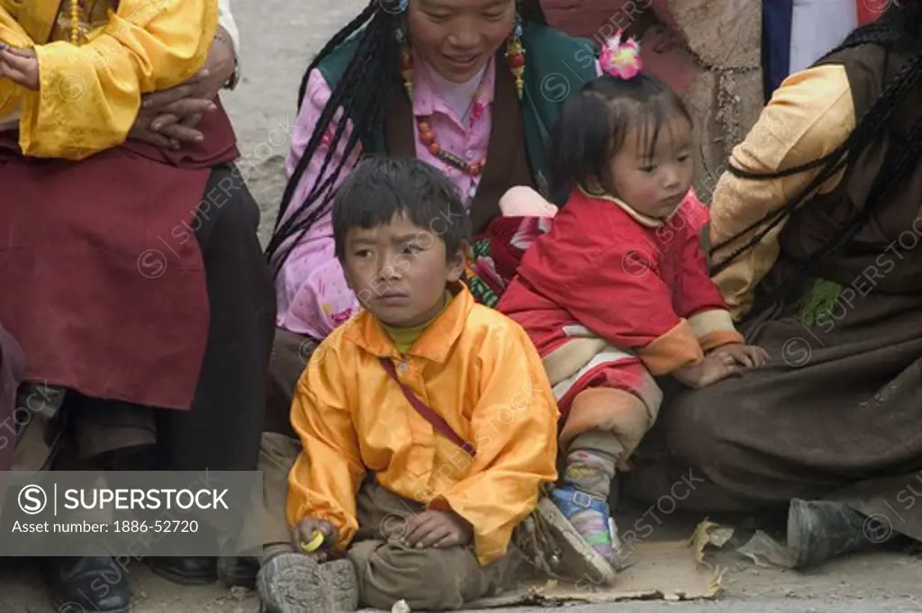 Khampas children at the Monlam Chenmo masked dances, Katok Dorjeden Monastery - Kham, (eastern, Tibet), Sichuan, China