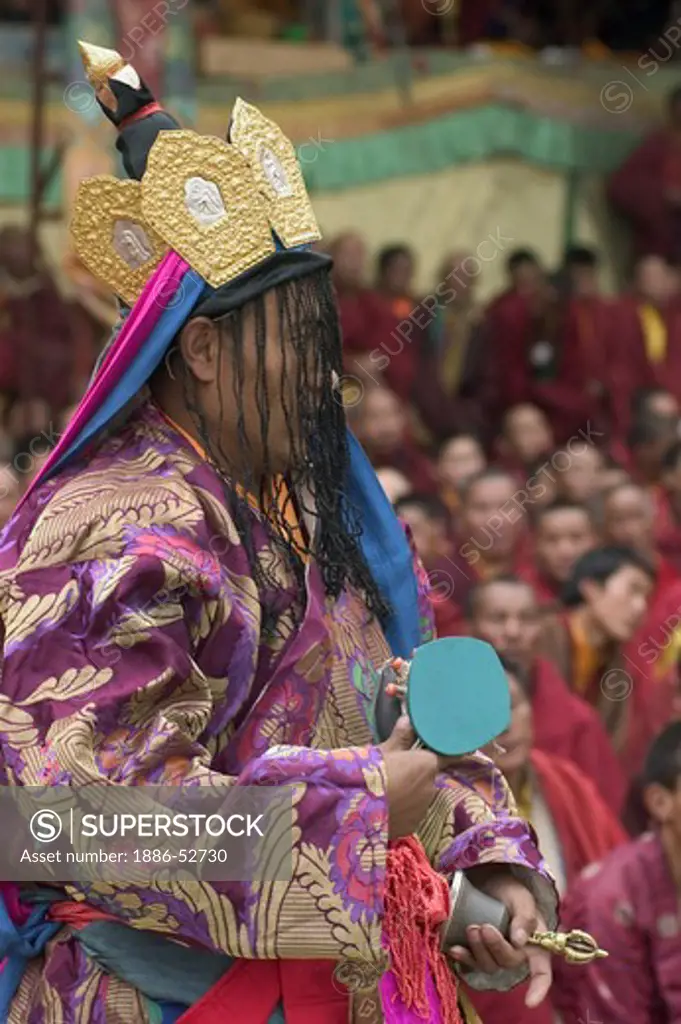 Nyingma monk with damaru drums at the Cham dances, Katok Dorjeden Monastery - Kham, (E. Tibet), Sichuan Province, China