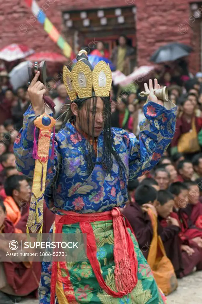 Nyingma monk with damaru drum & bell at the Cham dances, Katok Dorjeden Monastery - Kham, (Tibet), Sichuan Province, China