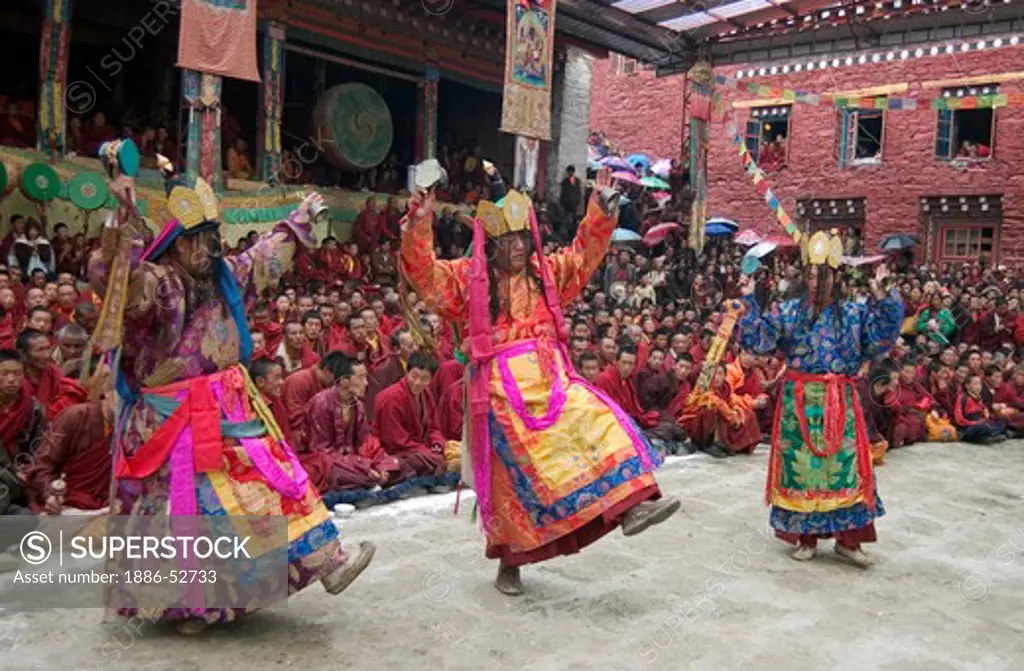 Nyingma monks with damaru drums & bells at the Cham dances, Katok Monastery - Kham, (Tibet), Sichuan Province, China