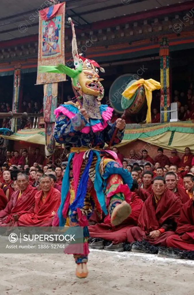 Masked dancer with skulls representing impermanence at the Cham dances, Katok Monastery - Kham, (Tibet), Sichuan, China