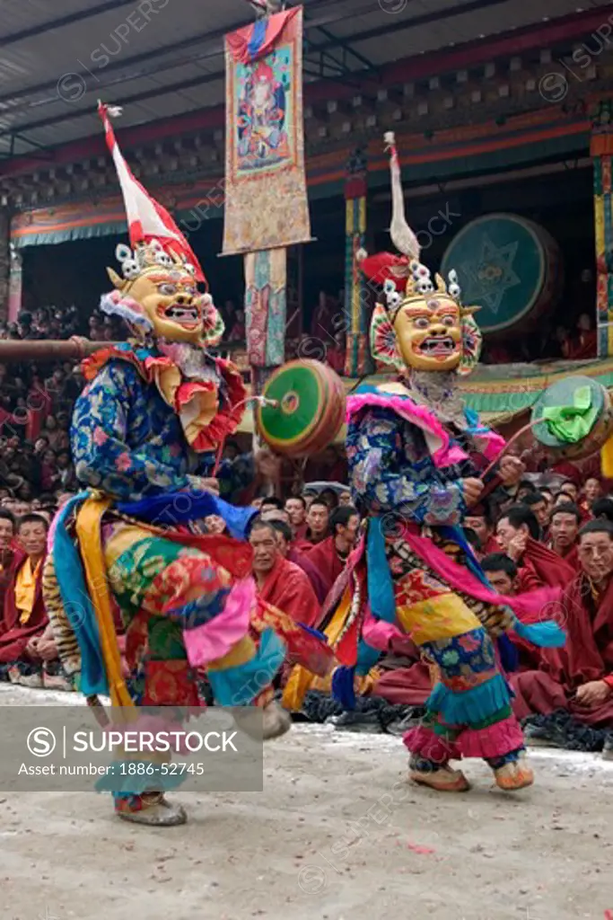 Masked dancers with skulls representing impermanence at the Cham dances, Katok Monastery - Kham, (Tibet), Sichuan, China