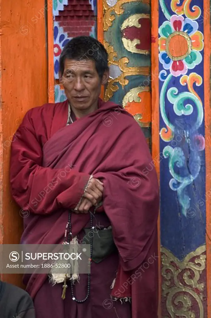 Tibetan Buddhist monk at the Monlam Chenpo, Katok Dorjeden Monastery - Kham, (eastern, Tibet), Sichuan Province, China