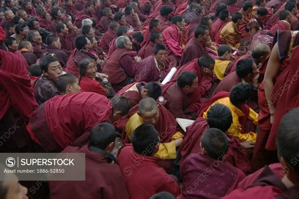 Buddhist monks watch the Monlam Chenpo dances celebrating Padmasambhava, Katok  Monastery - Kham, (Tibet), Sichuan, China