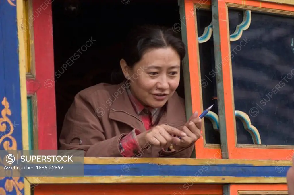 Tibetan woman anthropologist at the Nyingmapa sect Katok Dorjeden Monastery - Kham, (eastern, Tibet), Sichuan, China