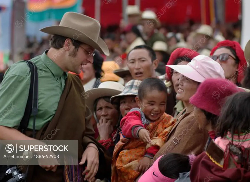 American man talks with the Khampa crowd at the  Litang Horse Festival in Kham - Litang, Sichuan Province, China (Tibet)