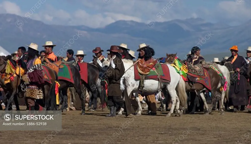 Khampas walk their horses back to the starting line at the Litang Horse Festival - Kham, Sichuan Province, China, (Tibet)