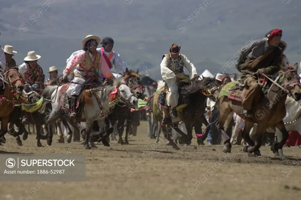 Khampas entertain the crowd in a rowdy horse race at the Litang Horse Festival - Kham, Sichuan Province, China, (Tibet)
