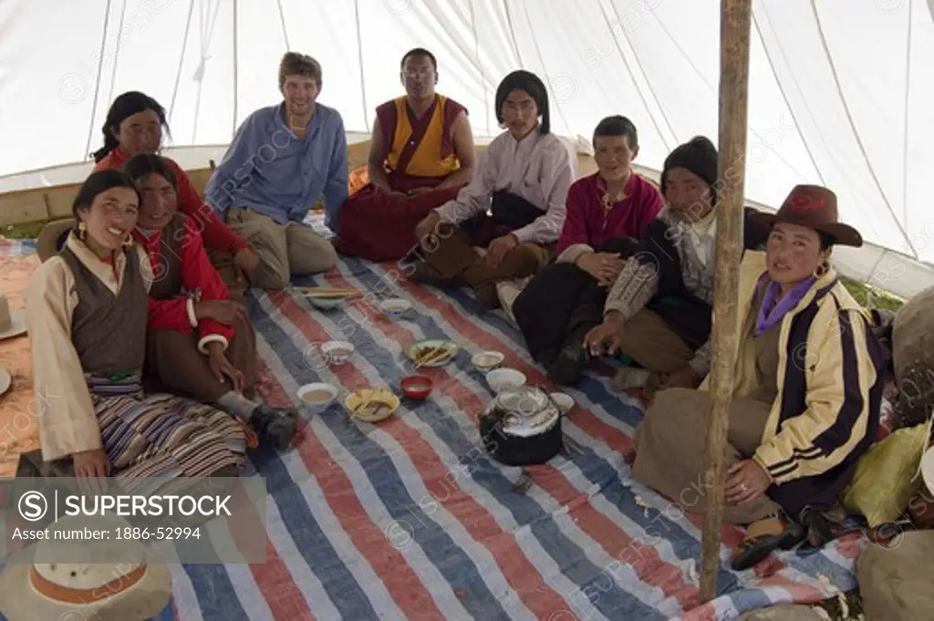 Friends gather in a tent for a meal at the Litang Horse Festival - Kham, Sichuan Province, China, (Tibet)