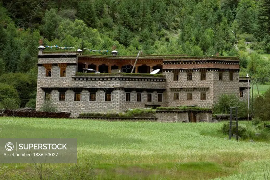 Tibetan style stone house, satelite dish and barley field in Dabpa County, Kham - Sichuan Province, China, (Tibet)
