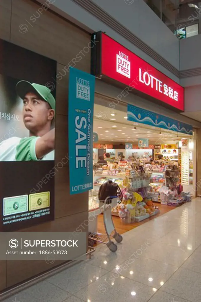 Airport terminal duty free stores with American Express add with Tiger Woods - Seoul, South Korea