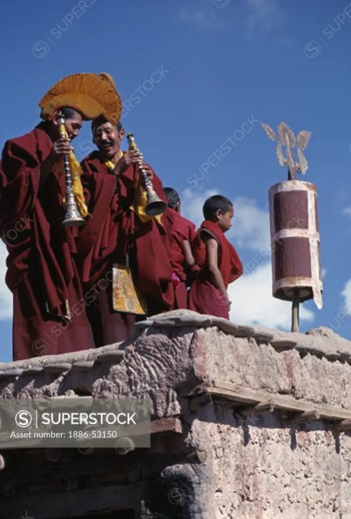GELUG (yellow hat) MONKS PLAY MUSIC on a rooftop overlooking the TIKSE Monastery GOSTOR (mask dances) - LADAKH, INDIA