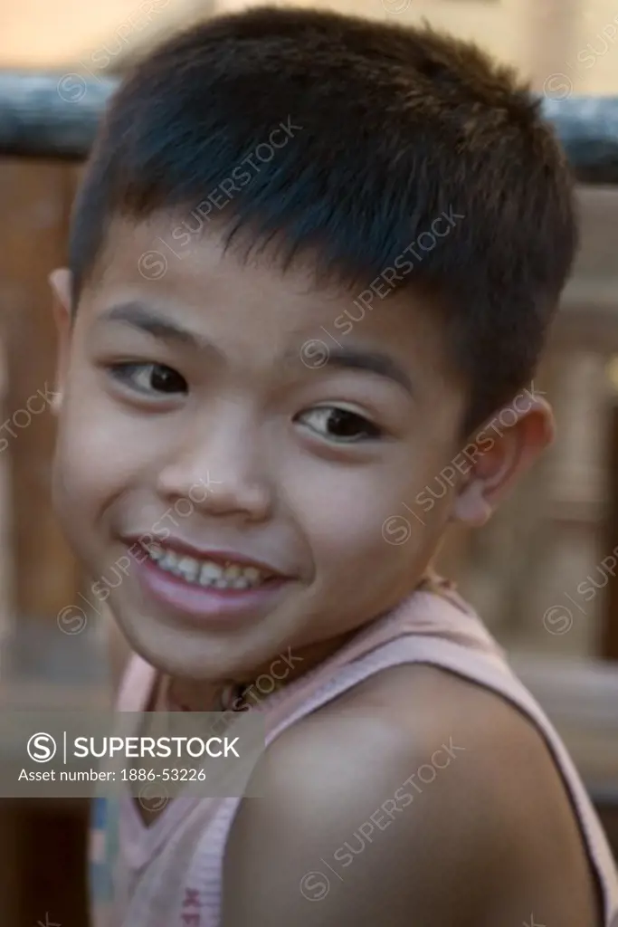 Young boy in a village near LUANG PROBANG - LAOS