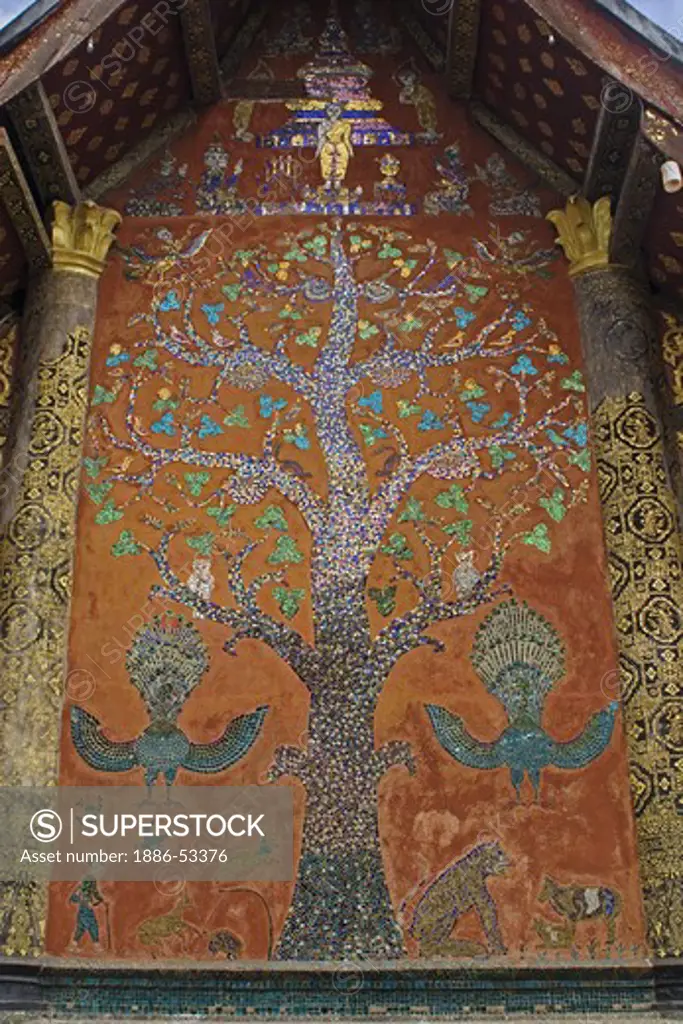Tree of Life mosaic made of glass on the back wall of the sim at Wat Xieng Thong, built by King Setthathirat in 1560 - LUANG PROBANG, LAOS