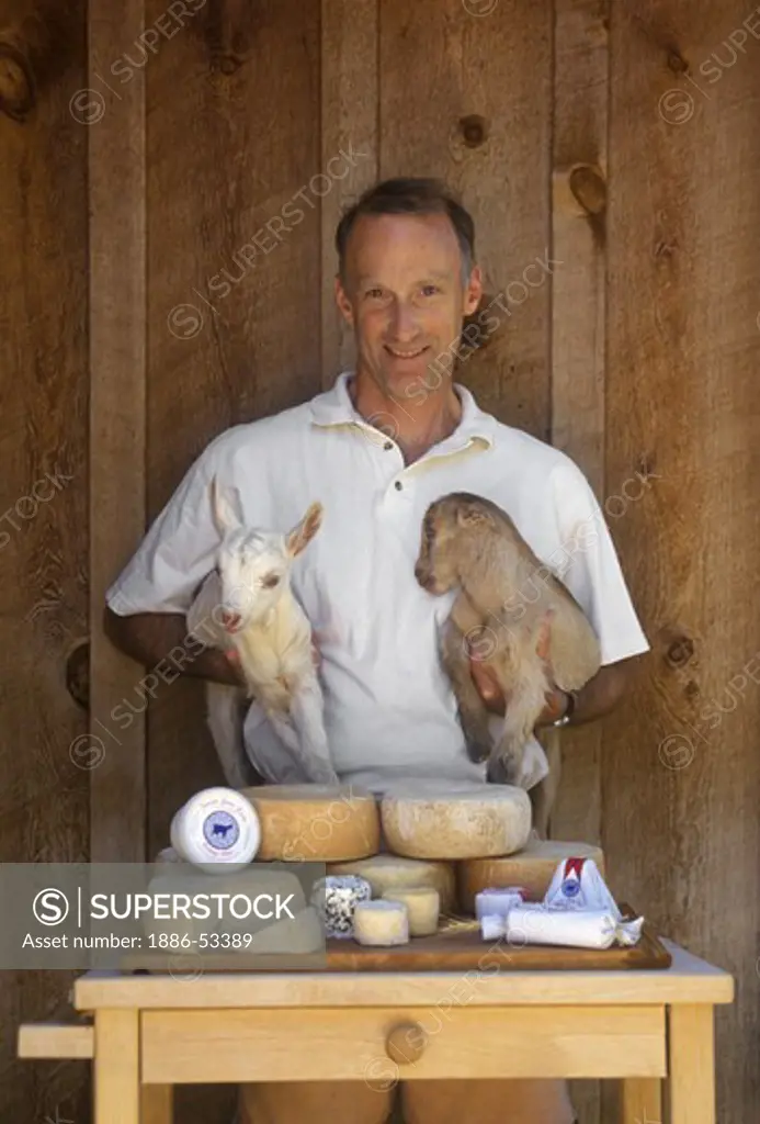 OWNER PIERRE  displays a variety of the GOAT CHEESES he produced at JUNIPER GROVE FARM - REDMOND, OREGON