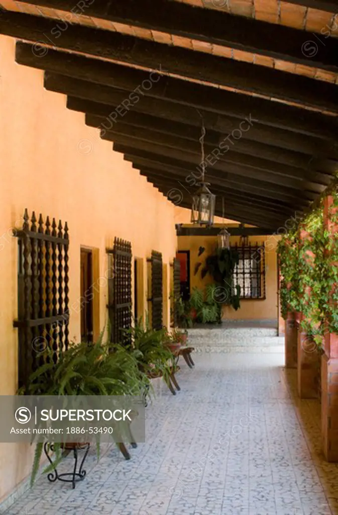 Wrought iron window grates wooden doorways and a covered walkway create the Mexican style of this hotel in SAN MIGUEL DE ALLENDE - MEXICO