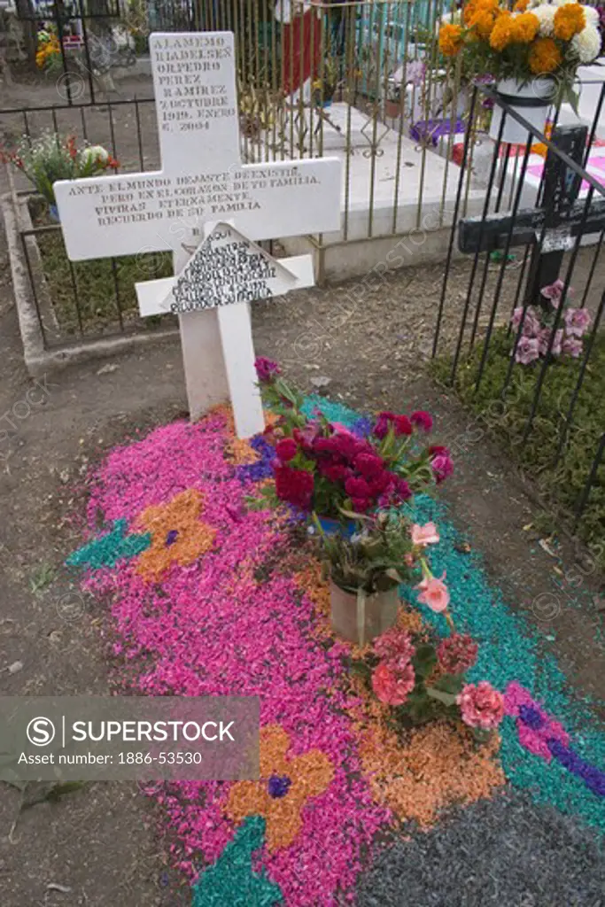 A grave is decorated with flowers and designs at the local cemetery during the DEAD OF THE DEAD - SAN MIGUEL DE ALLENDE, MEXICO