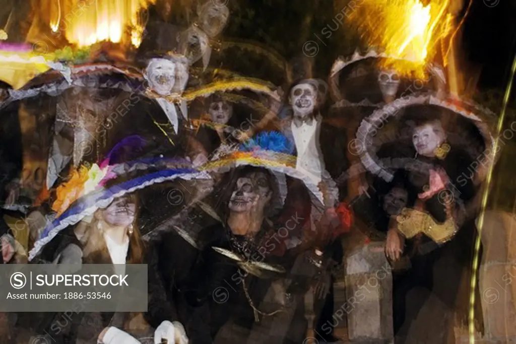 Adults dress up as skeletons and distribute candy to Mexican children during the DEAD OF THE DEAD - SAN MIGUEL DE ALLENDE, MEXICO