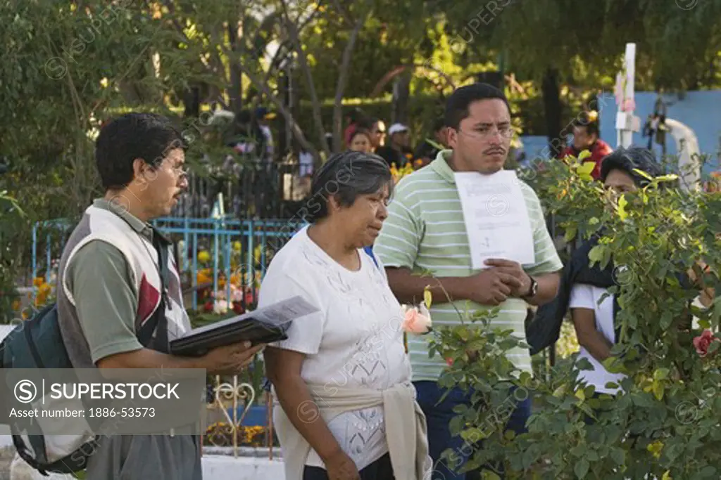 PRAYERS are said for the dead at the cemetery during the DEAD OF THE DEAD - SAN MIGUEL DE ALLENDE, MEXICO