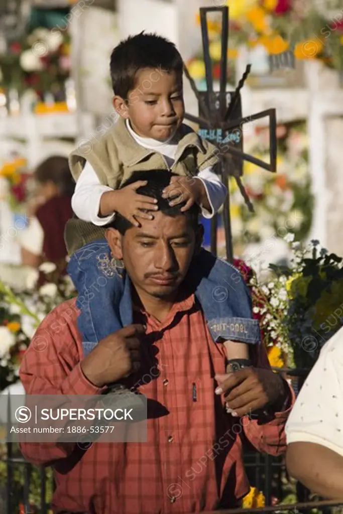 Father and son at the CEMETERY during the DEAD OF THE DEAD - SAN MIGUEL DE ALLENDE, MEXICO