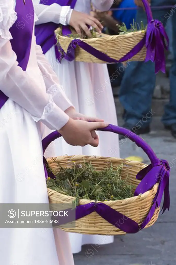 MEXICAN GIRL throws flowers during EASTER PROCESSION commencing at TEMPLO DEL ORATORIO - SAN MIGUEL DE ALLENDE, MEXICO