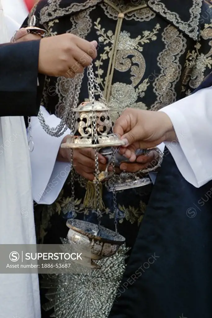 PRIESTS fill incense burner during the EASTER PROCESSION - SAN MIGUEL DE ALLENDE, MEXICO