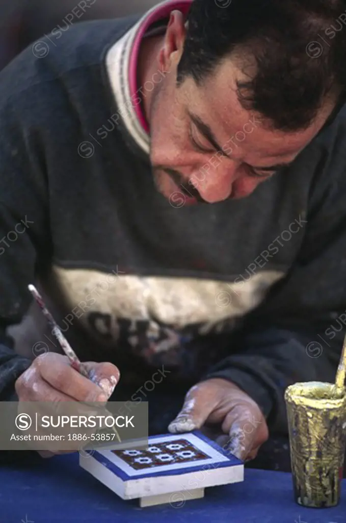 FURNITURE PAINTER in the town of CHECHAOUEN in the RIF MOUNTAINS of northern MOROCCO