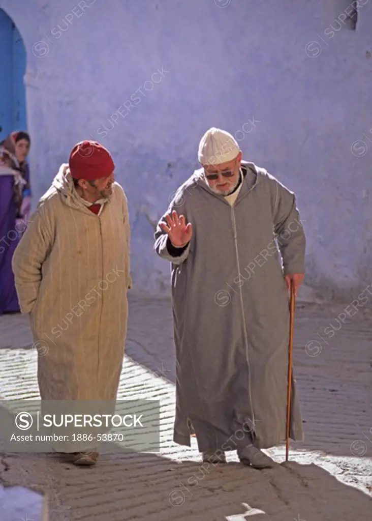 Men discuss the KORAN while walking in the MEDINA in CHECHAOUEN in the RIF MOUNTAINS of northern MOROCCO