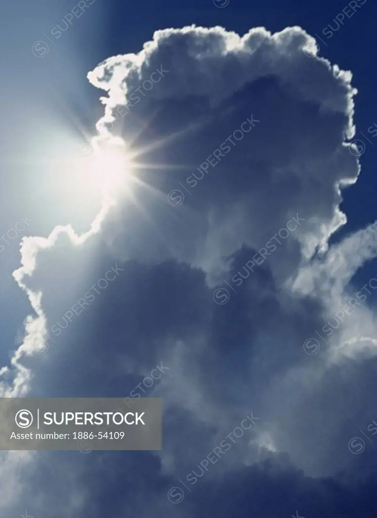 The SUN shines from behind a CUMULUS CLOUD as WEATHER moves over the CENTRAL VALLEY - CALIFORNIA