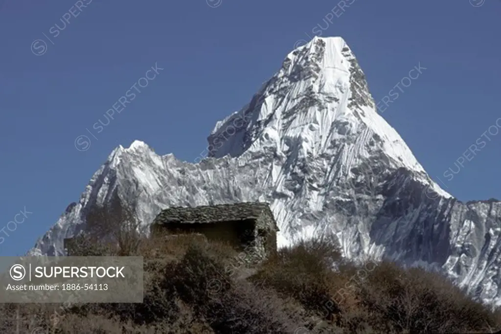 A tea house sits in front of Ama Dablam (which means mother cradling a child) & reaches a height of 22,493 ft - Khumbu Region