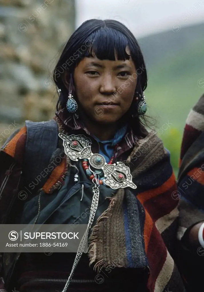 A NEPALI GIRL wearing DOLPO BLANKET and dorje shaped SILVER CLASP at the upper DO TARAP VALLEY FESTIVAL - DOLPO, NEPAL