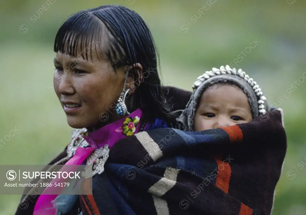 WOMAN and CHILD in DOLPO BLANKET and silver clasp at a Tibetan Buddhist FESTIVAL in DO TARAP VALLEY - DOLPO, NEPAL